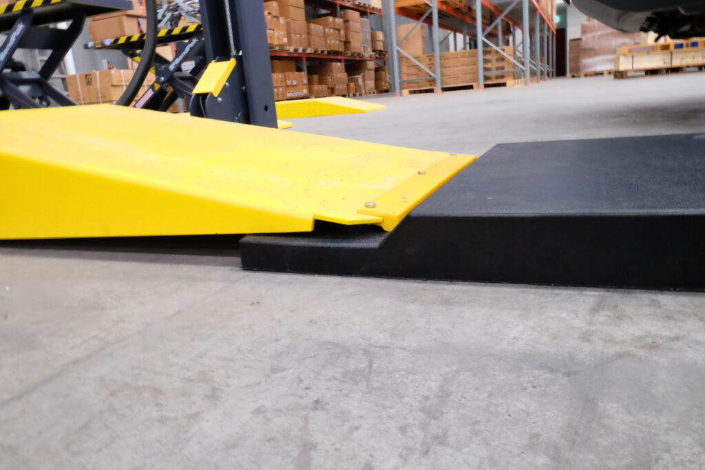close up of extension ramps attached to a car lift in an automotive workshop - Genesis Equipment Australia